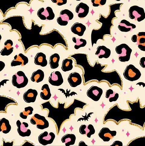 A repeating Halloween-themed pattern featuring black bats, leopard spots in black, orange, and pink, and small pink sparkles on a cream background with gold glitter-style outlines.