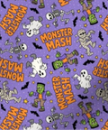 Purple Halloween-themed fabric with a repeating 'Monster Mash' pattern featuring cartoon mummies, skeletons, ghosts, Frankenstein's monster, bats, and stars.