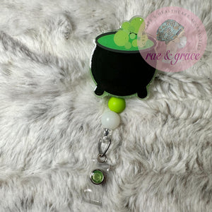 
            
                Load image into Gallery viewer, Witch&amp;#39;s Cauldron - Glow In The Dark - Badge Reel
            
        